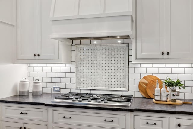 kitchen with white cabinetry, tasteful backsplash, stainless steel gas stovetop, and custom exhaust hood