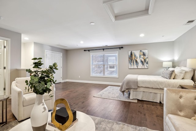 bedroom with ornamental molding and dark hardwood / wood-style floors