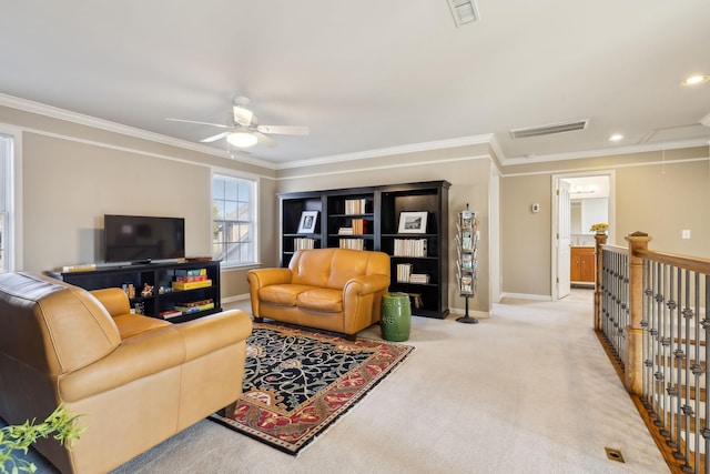 living room featuring crown molding, light colored carpet, and ceiling fan