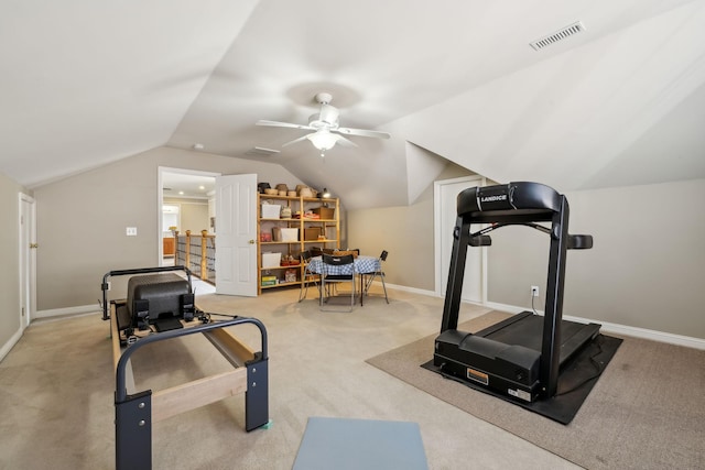 workout room with ceiling fan, carpet flooring, and vaulted ceiling