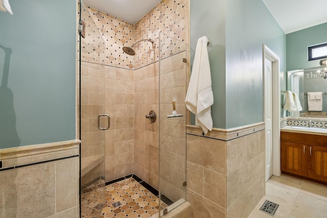 bathroom featuring vanity, tile walls, and walk in shower