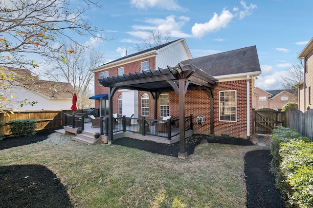 back of house with a wooden deck, a yard, and a pergola