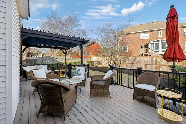 deck featuring a pergola and an outdoor hangout area