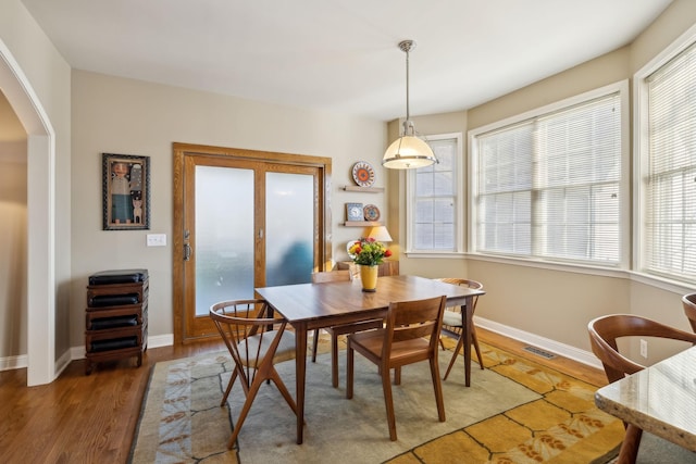 dining room with dark hardwood / wood-style flooring