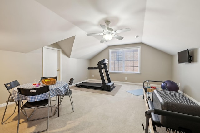 workout room with vaulted ceiling, light colored carpet, and ceiling fan