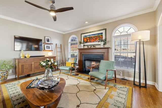 living room with hardwood / wood-style flooring, ornamental molding, and plenty of natural light