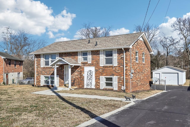 raised ranch with a garage, an outbuilding, and a front yard