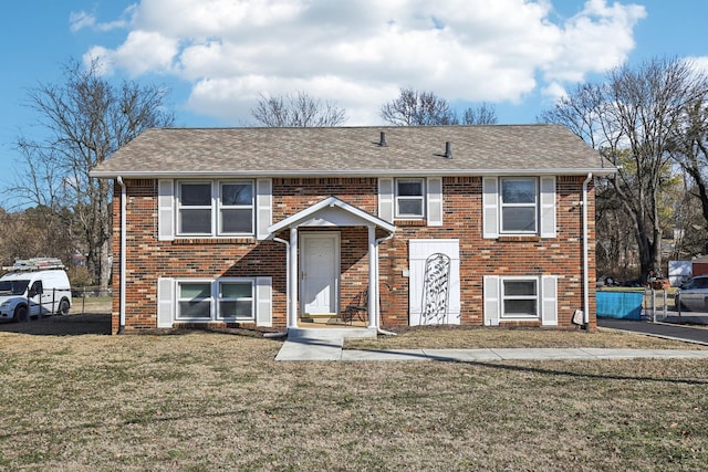 bi-level home with a front lawn