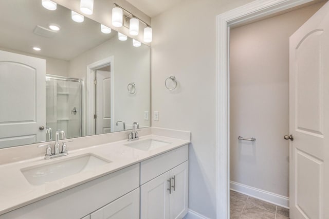 bathroom with an enclosed shower, vanity, and tile patterned floors