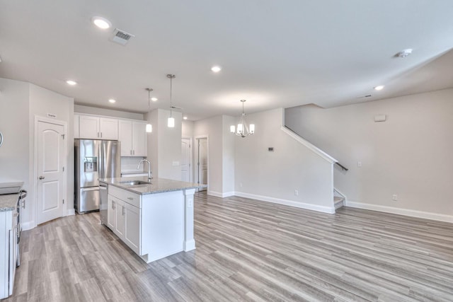 kitchen featuring white cabinetry, an island with sink, stainless steel appliances, and sink