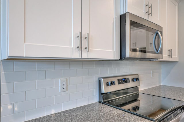 kitchen with white cabinetry, appliances with stainless steel finishes, and decorative backsplash