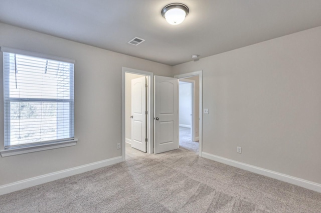 empty room featuring light carpet