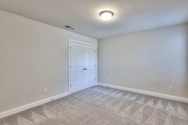 unfurnished bedroom with carpet floors and a closet