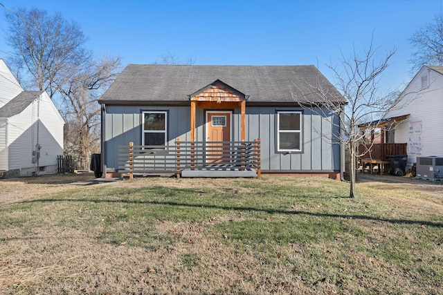 bungalow featuring a front yard and central AC unit