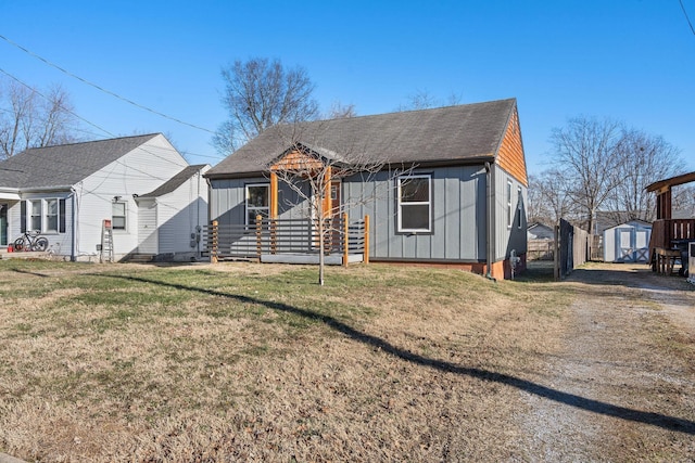 view of front of house with a front lawn and a storage unit