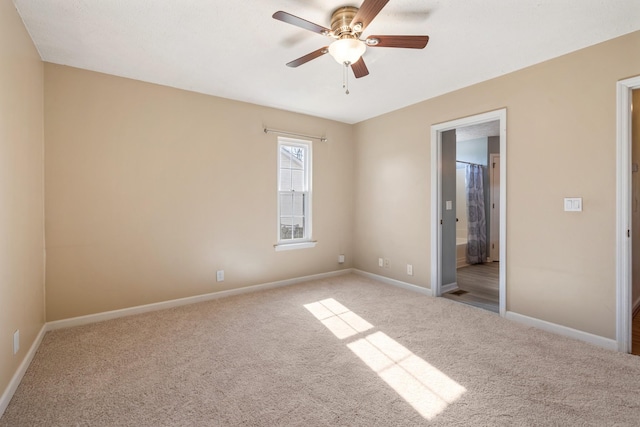 unfurnished bedroom with connected bathroom, light colored carpet, and ceiling fan