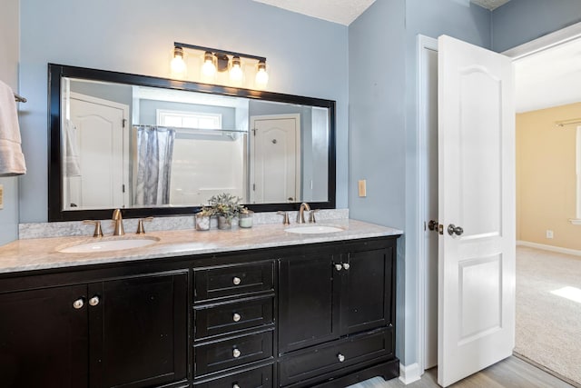 bathroom featuring vanity, hardwood / wood-style floors, and walk in shower