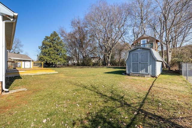 view of yard with a wooden deck and a shed