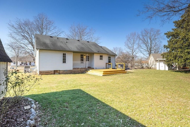 rear view of property featuring a shed, a wooden deck, and a lawn