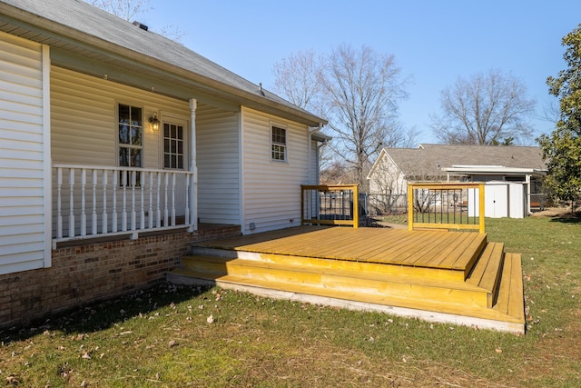 wooden terrace featuring a shed and a yard