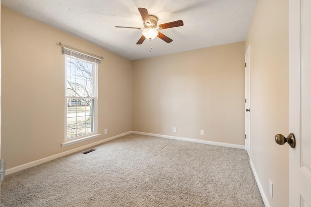 spare room with light carpet, a textured ceiling, and ceiling fan