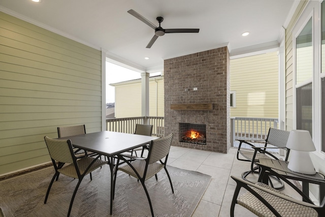 view of patio / terrace featuring an outdoor brick fireplace and ceiling fan