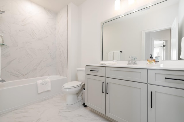 full bathroom featuring tiled shower / bath, vanity, and toilet