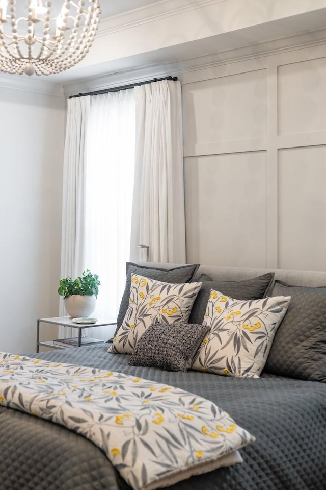 bedroom featuring ornamental molding and a chandelier