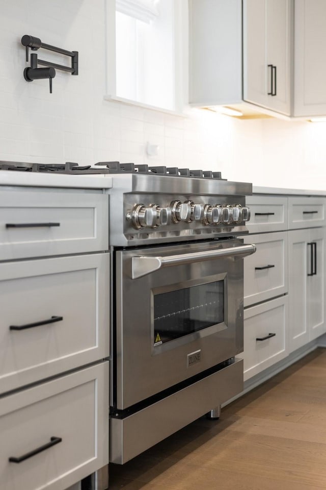 kitchen featuring stainless steel range and light wood-type flooring