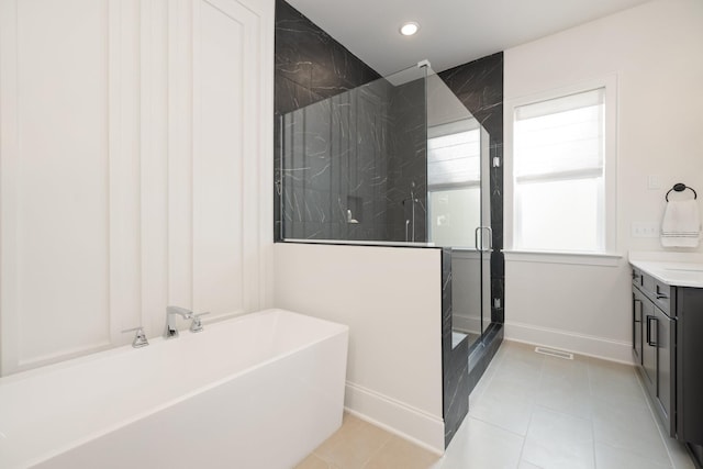 bathroom featuring vanity, shower with separate bathtub, and tile patterned flooring