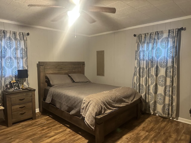 bedroom with ornamental molding, dark hardwood / wood-style flooring, and ceiling fan