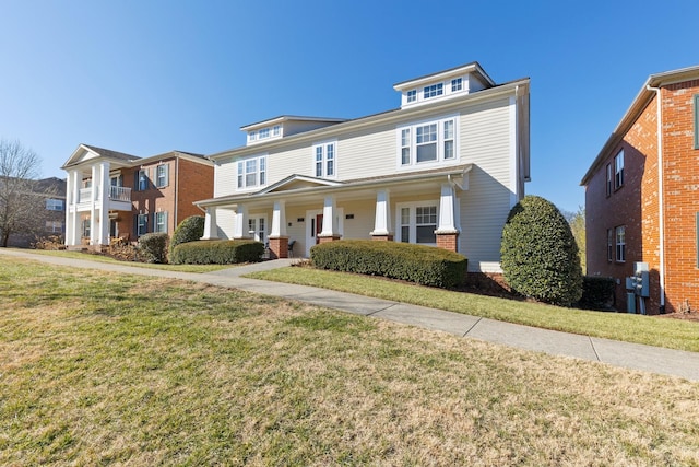 view of front of home with covered porch and a front yard