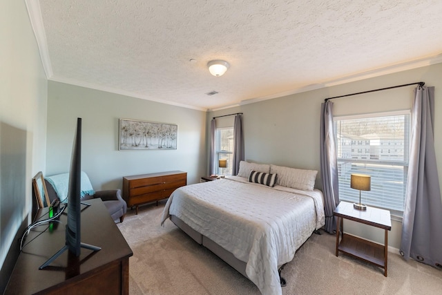 carpeted bedroom featuring ornamental molding and a textured ceiling