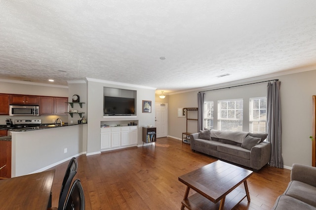 living room featuring hardwood / wood-style flooring, ornamental molding, and a textured ceiling