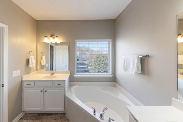 bathroom featuring vanity and a bath