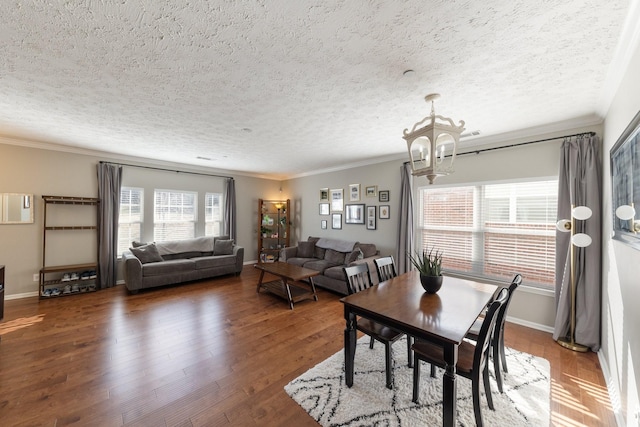 dining space featuring crown molding, dark wood-type flooring, and a notable chandelier