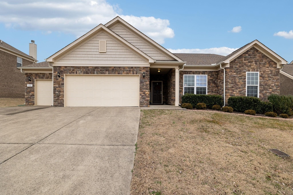 view of front facade with a garage and a front lawn