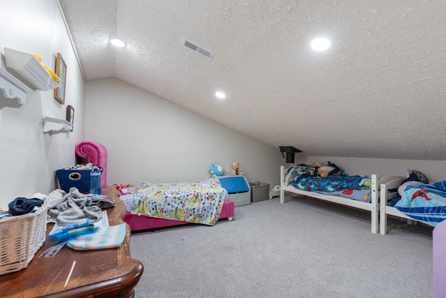 bedroom with lofted ceiling, carpet floors, and a textured ceiling