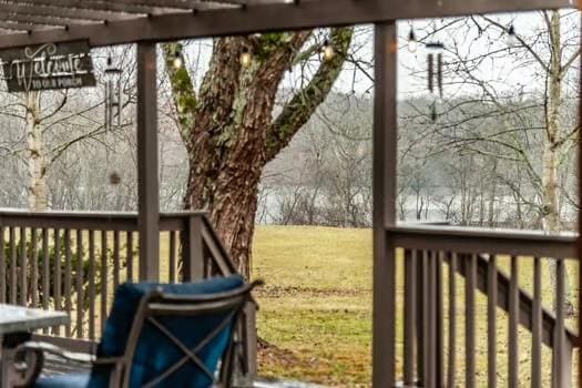 wooden deck featuring a lawn