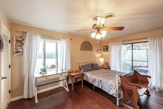 bedroom with multiple windows, access to outside, dark hardwood / wood-style floors, and ceiling fan