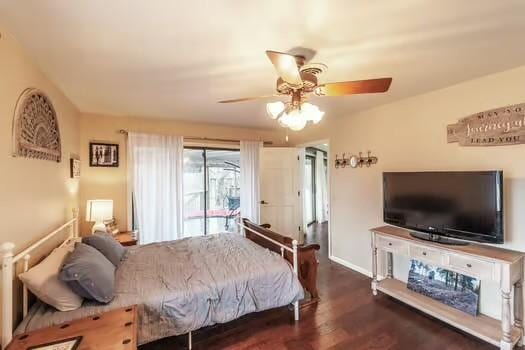 bedroom featuring ceiling fan, dark hardwood / wood-style flooring, and access to exterior