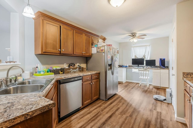 kitchen with pendant lighting, sink, light hardwood / wood-style flooring, ceiling fan, and appliances with stainless steel finishes