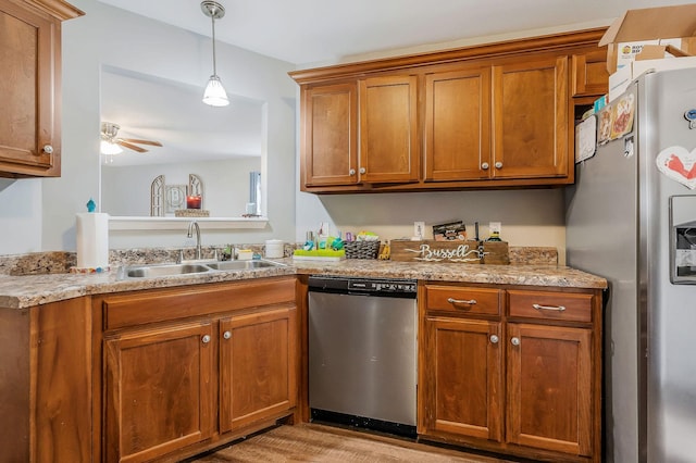 kitchen with pendant lighting, sink, ceiling fan, and appliances with stainless steel finishes