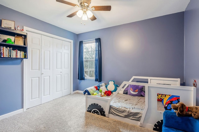 carpeted bedroom with ceiling fan and a closet