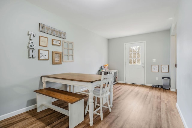 dining space featuring wood-type flooring