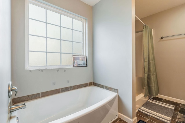 bathroom featuring tile patterned floors and independent shower and bath