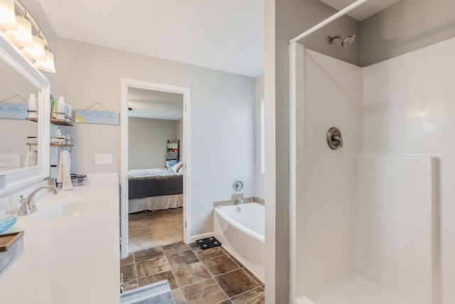 bathroom featuring plus walk in shower and sink