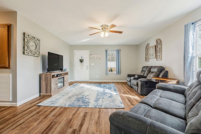 living room with ceiling fan and light hardwood / wood-style flooring