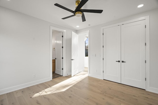 unfurnished bedroom with ceiling fan, light hardwood / wood-style floors, and a closet