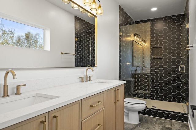 bathroom featuring vanity, toilet, and an enclosed shower